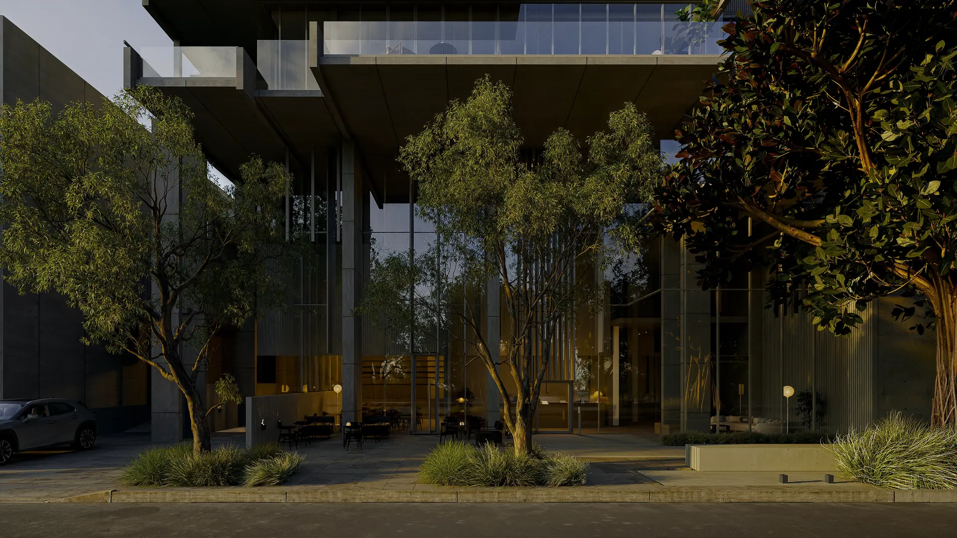 Acceso de Urban Plaza al atardecer, con árboles sobre la vereda